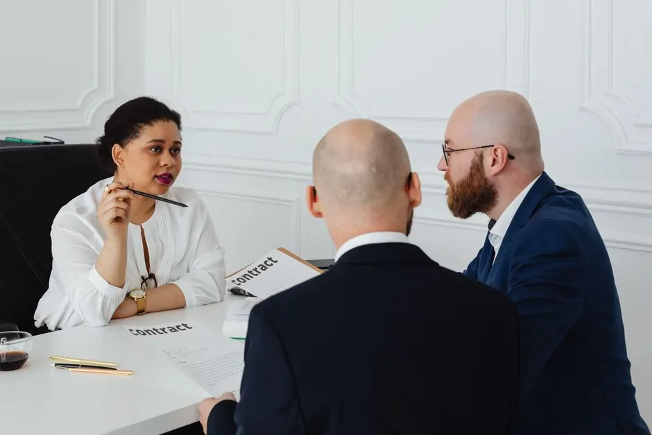 Business colleagues meeting in an office to discuss a contract negotiation.