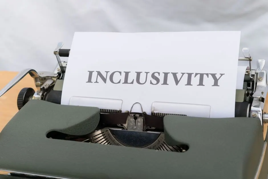 Close-up of a vintage typewriter printing the message 'INCLUSIVITY' on paper.